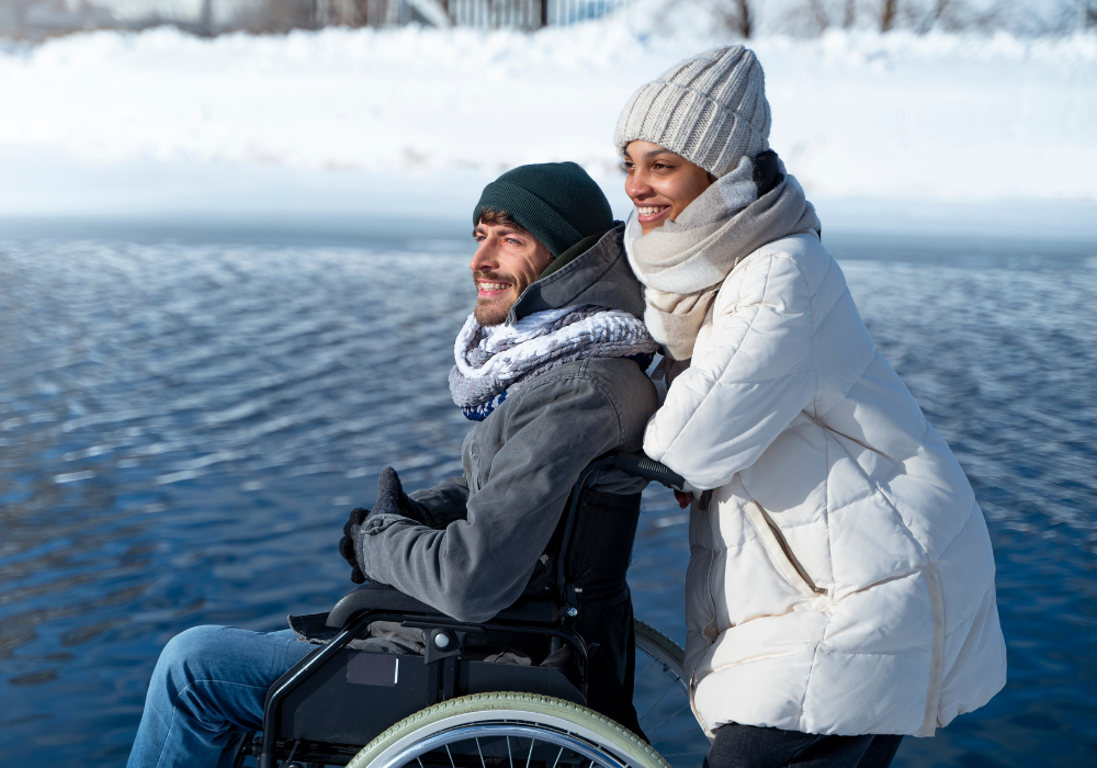 Wheelchair user out on a winter walk with his friend